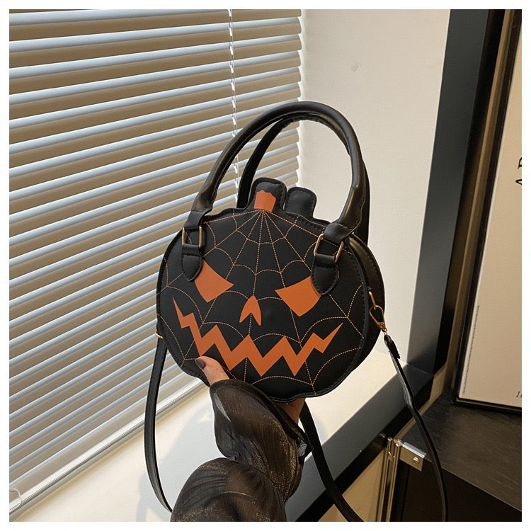 black and orange pumpkin purse
