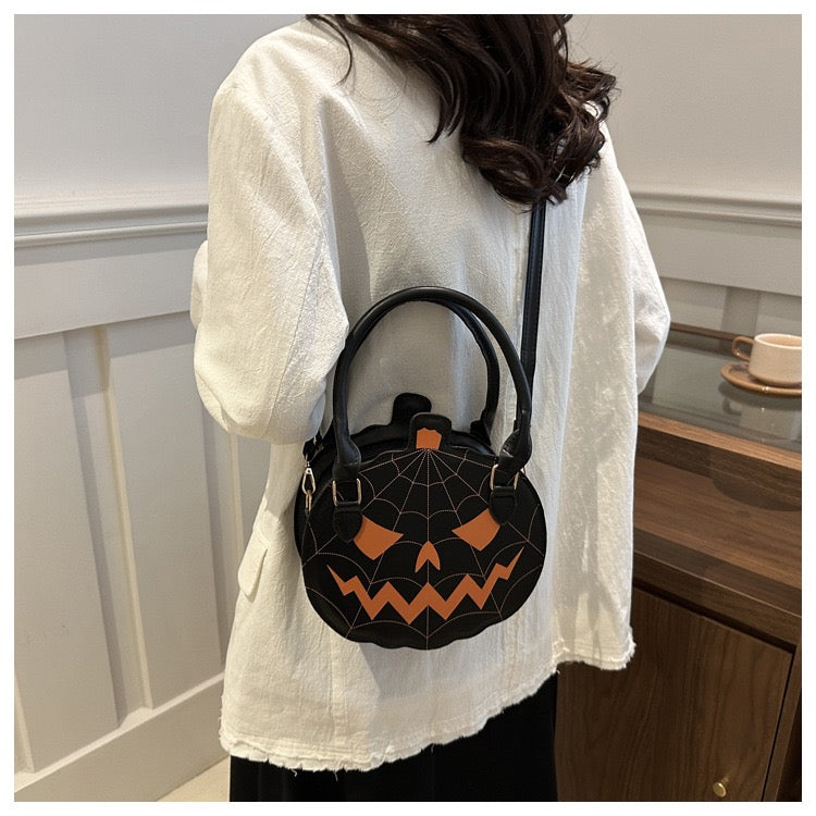 black and orange pumpkin purse